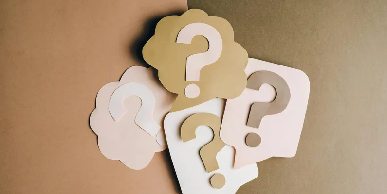 Four posters, each with a question mark in the middle of them