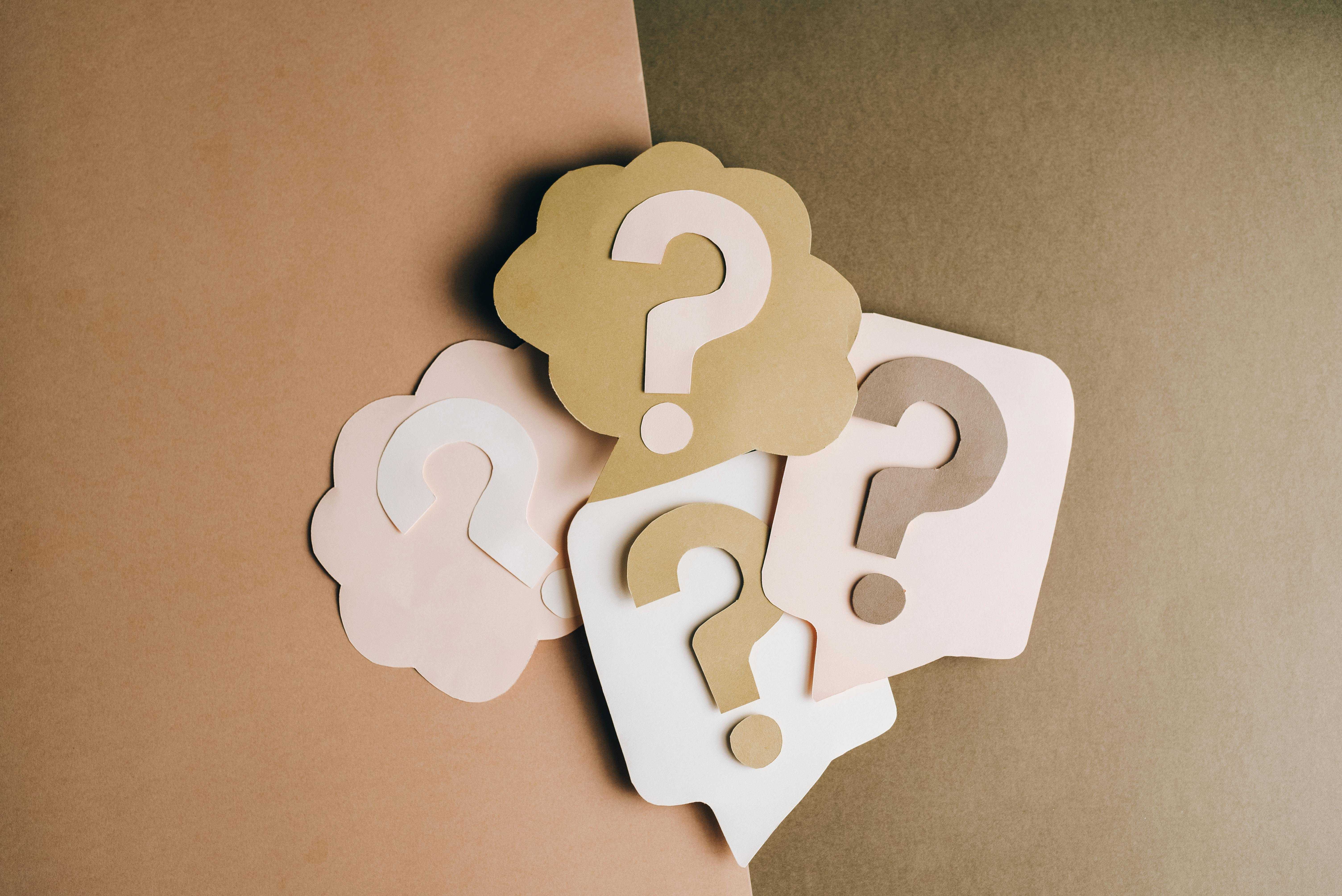 Four posters, each with a question mark in the middle of them