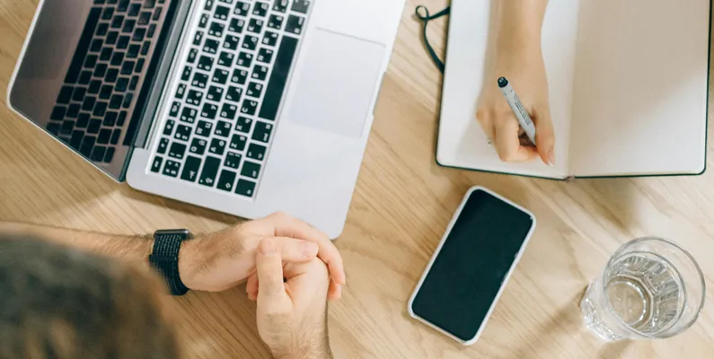 Two people researching keywords for their blog