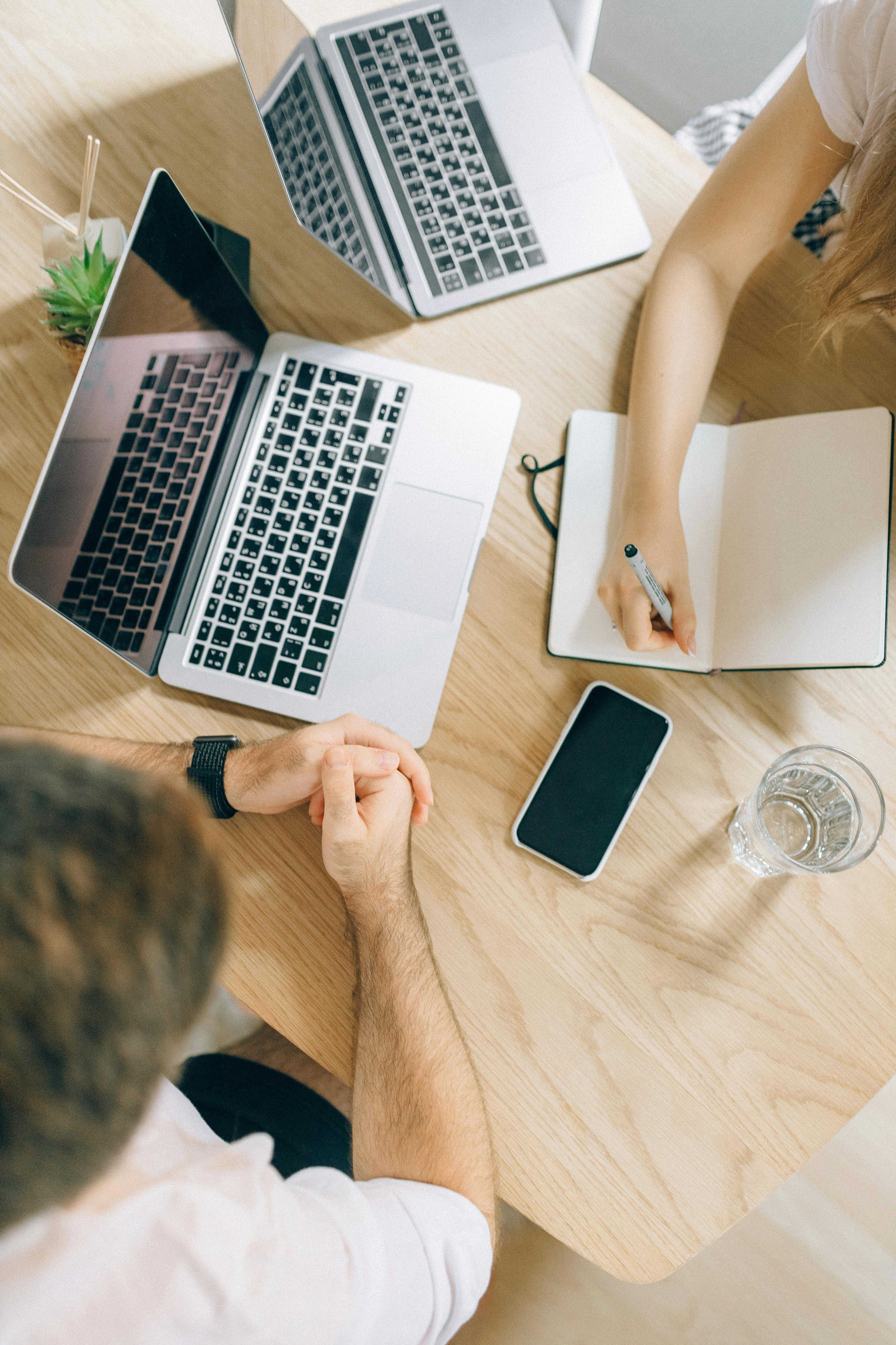 Two people researching keywords for their blog